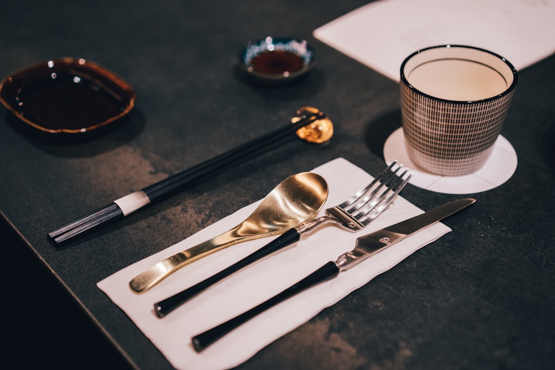 silver fork and bread knife on black table,