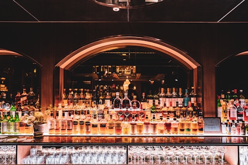 brown wooden shelf with bottles
