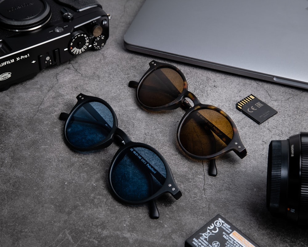 black framed sunglasses on gray table