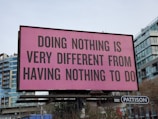a large pink billboard with a quote on it