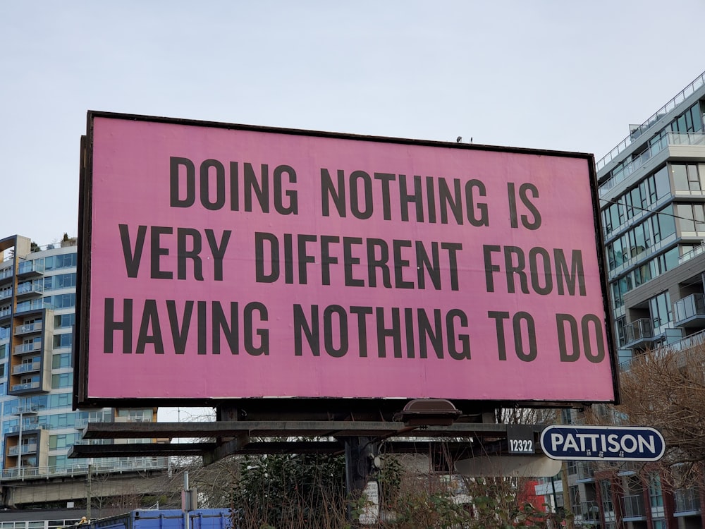 a large pink billboard with a quote on it