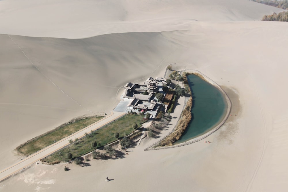 aerial view of white and gray house on white sand beach during daytime