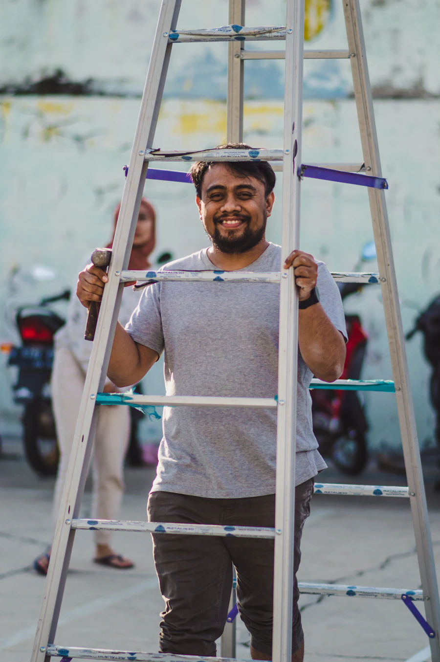 Sam carrying a ladder to the next room