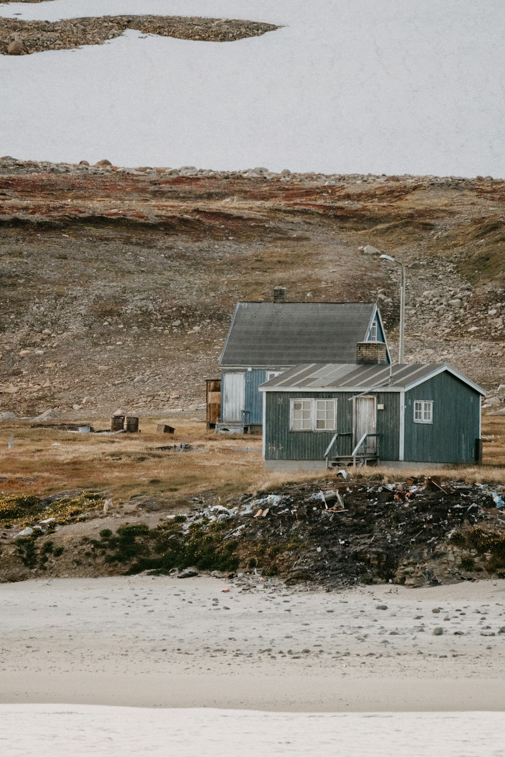 gray wooden house on brown field during daytime