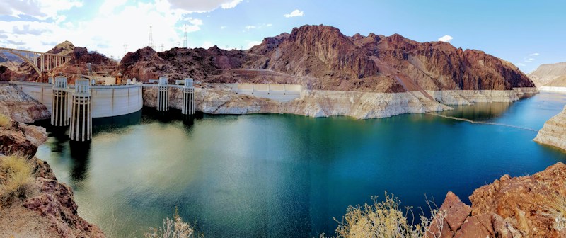 Hoover Dam intake towers above the blue-green water of Lake Mead, a short drive from the Boulder City Adventure Center