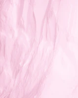 Close-up of delicate pink pastel fabric texture representing the softness and care of menstrual underwear.