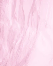 Close-up of a smooth, shiny silk pillowcase in soft pastel colors.