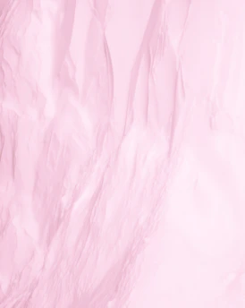 Close-up of a soft pastel pink menstrual underwear fabric gently folded on a black background.
