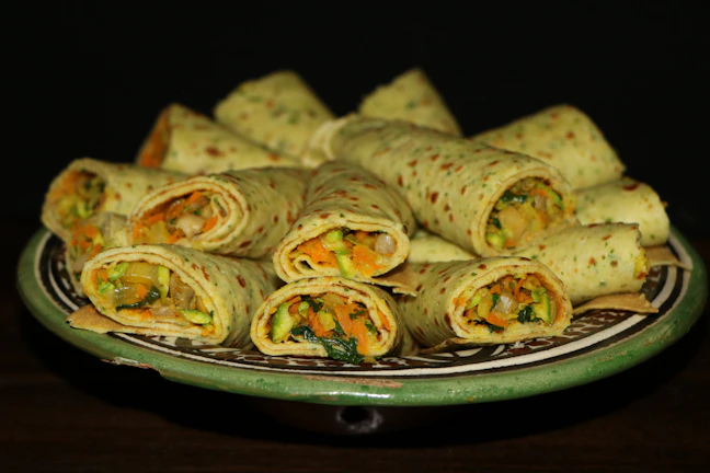 A vibrant spread of fresh, colorful salads and wraps arranged for a corporate meeting.