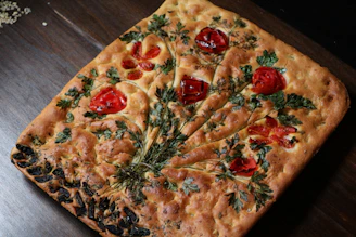 A beautiful homemade focaccia bread showcasing fresh herbs.