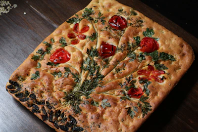 A beautiful homemade focaccia bread showcasing fresh herbs.