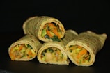 Hand-rolled wraps being prepared with organic vegetables.