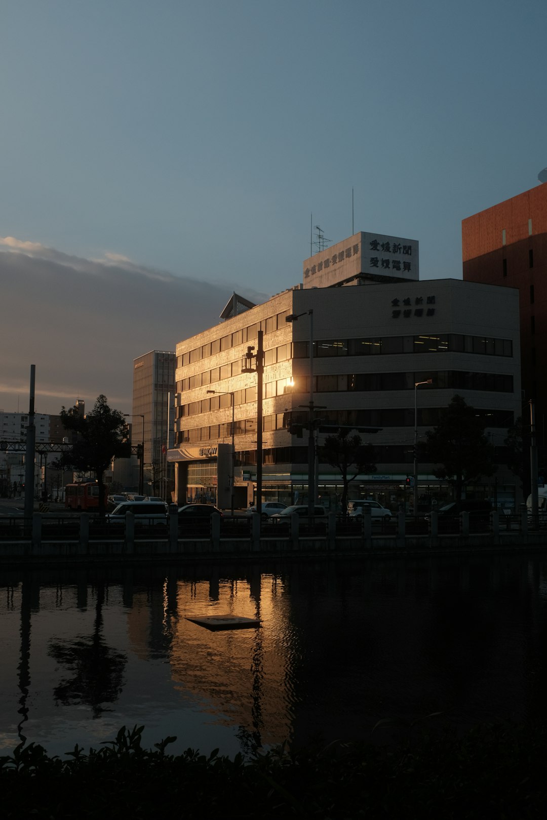 white and brown concrete building near body of water during daytime