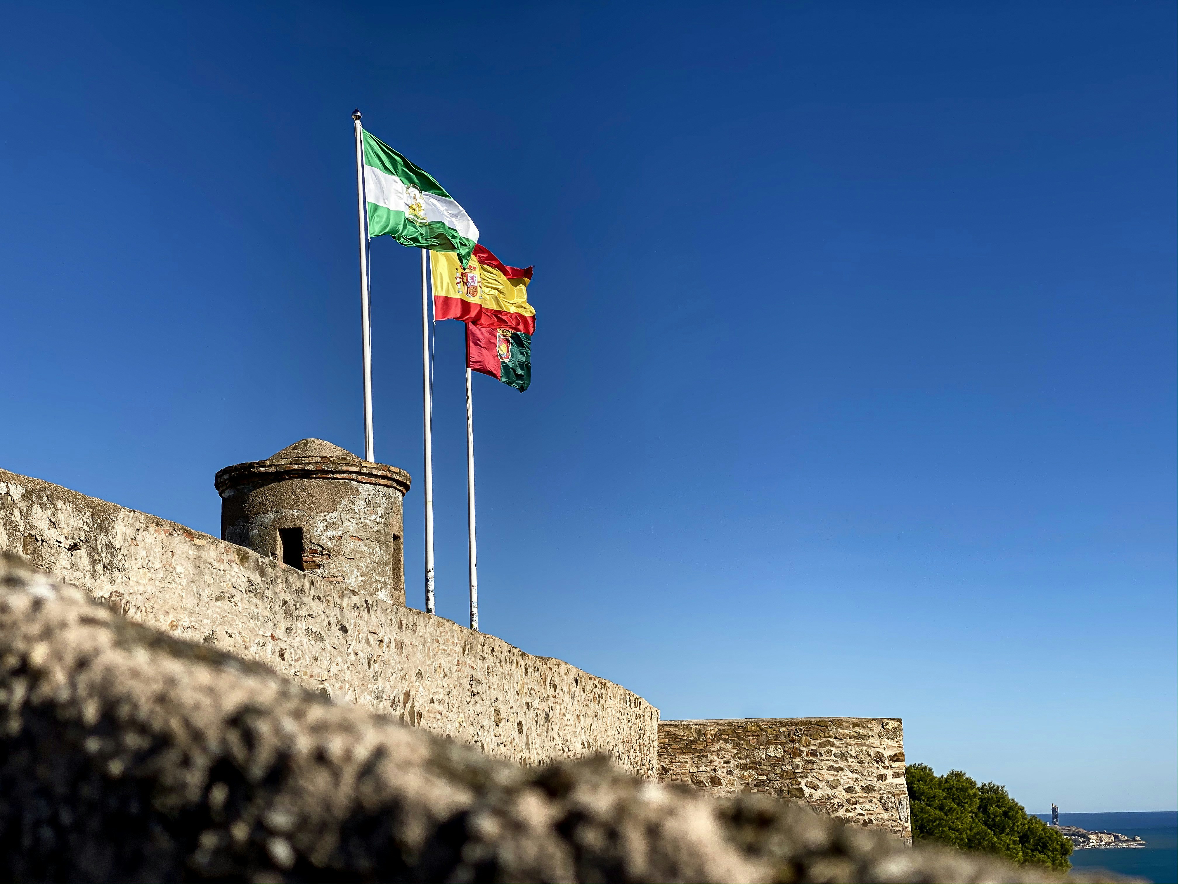 green white and red flag on pole under blue sky during daytime