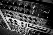 Workshop scene showing vintage pre amps, reverbs, and compressors lined up on a wooden bench.