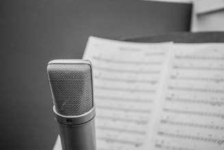 A close-up of a microphone surrounded by musical notes.