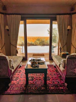 Elegant family suite featuring plush bedding and balcony facing the tranquil valley.