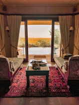 Elegant suite with separate living area, plush seating, and panoramic views.