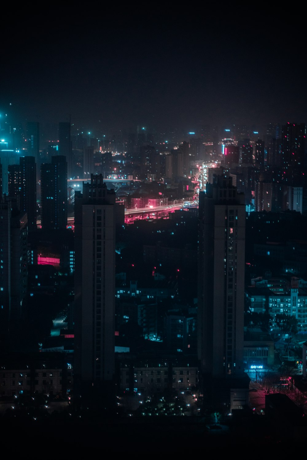 city with high rise buildings during night time