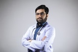 man in white dress shirt wearing black framed eyeglasses