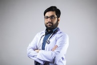 man in white dress shirt wearing black framed eyeglasses