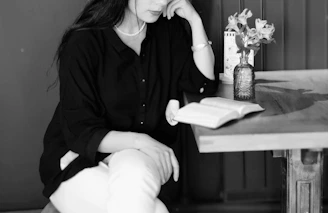 A serene workspace with a calm woman sitting peacefully with a notebook, embodying mental harmony