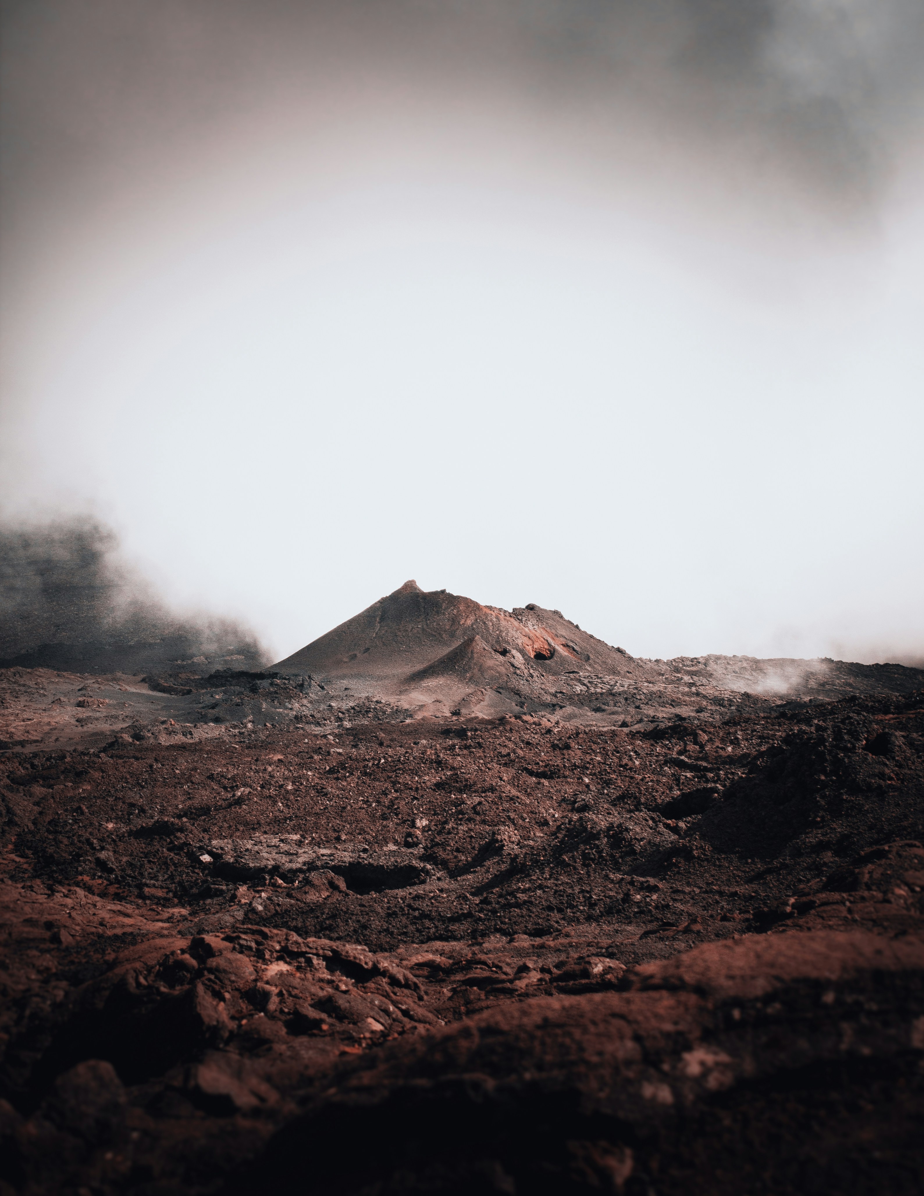 brown and white mountain under white clouds