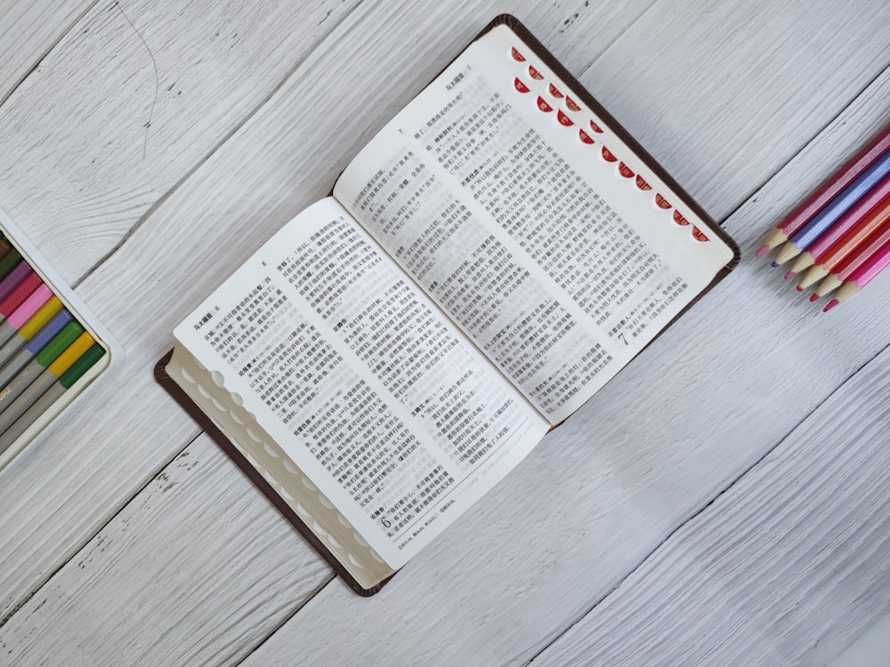 white and black labeled book on gray wooden table