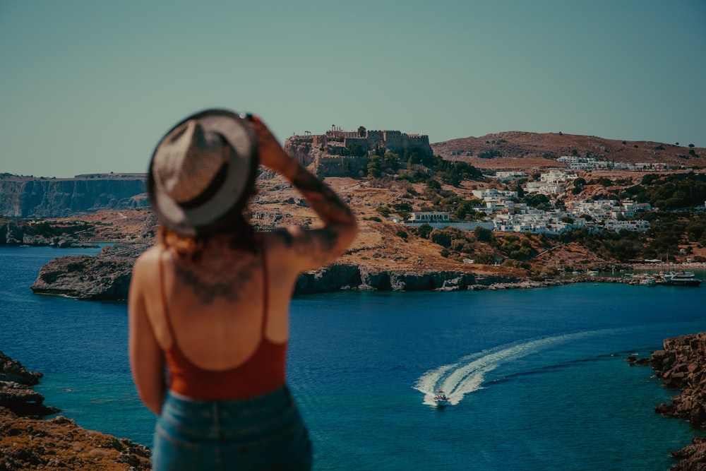 woman in blue denim shorts standing on top of building during daytime