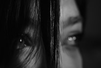 Close-up of a black-and-white photo of a city hunter with a focused gaze.