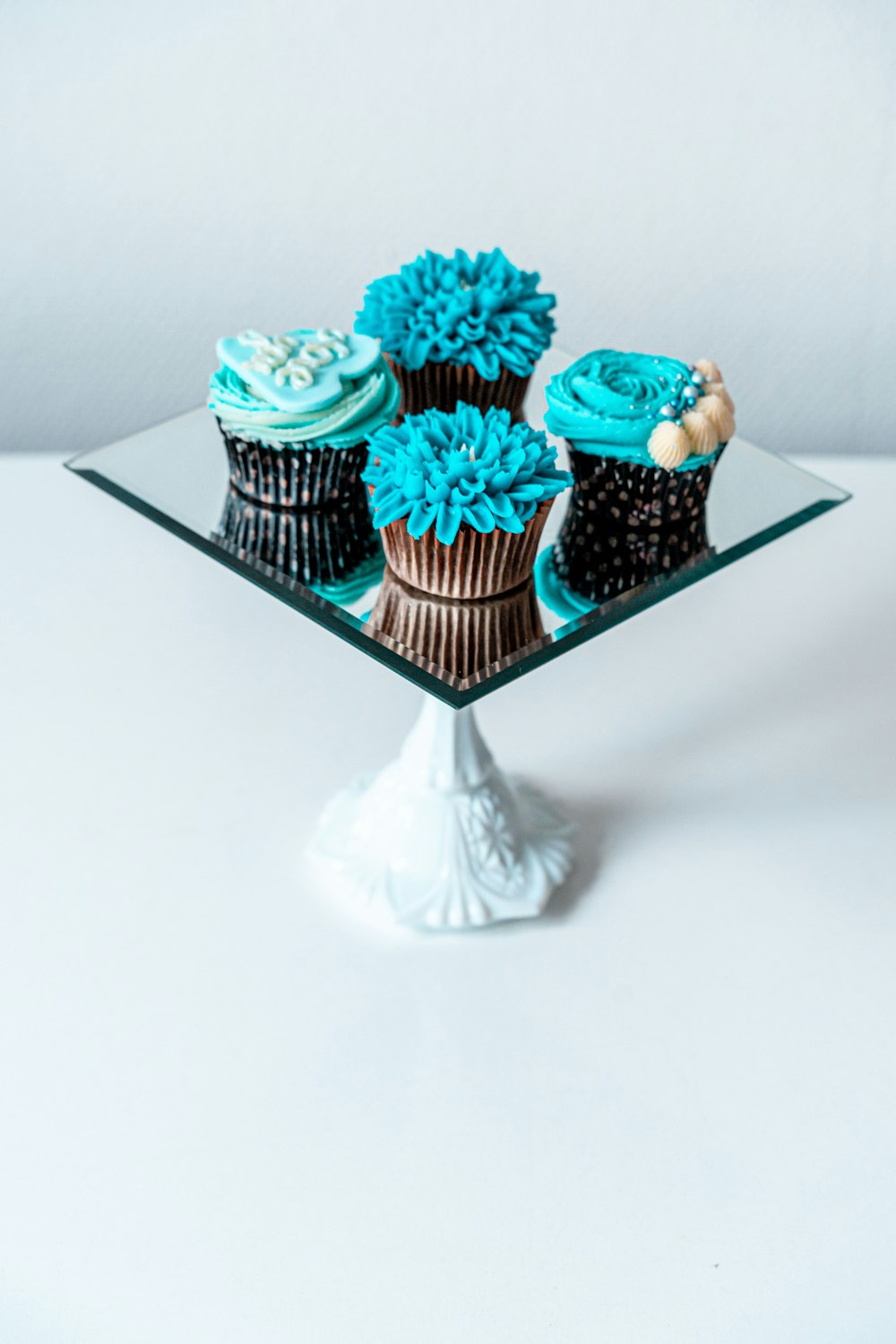 2 pink and white cupcakes on tray