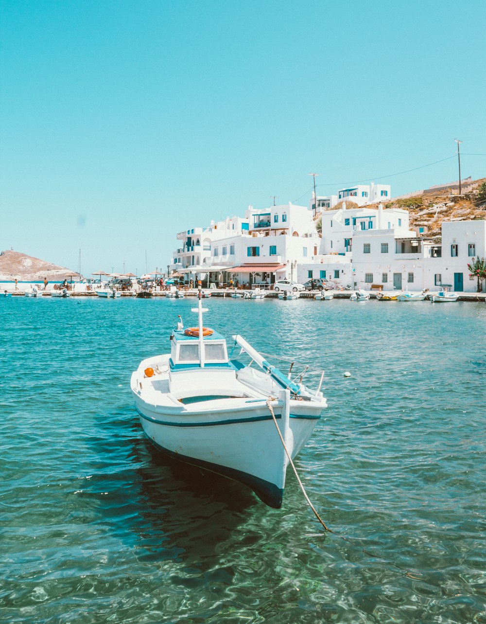 white and blue boat on sea during daytime