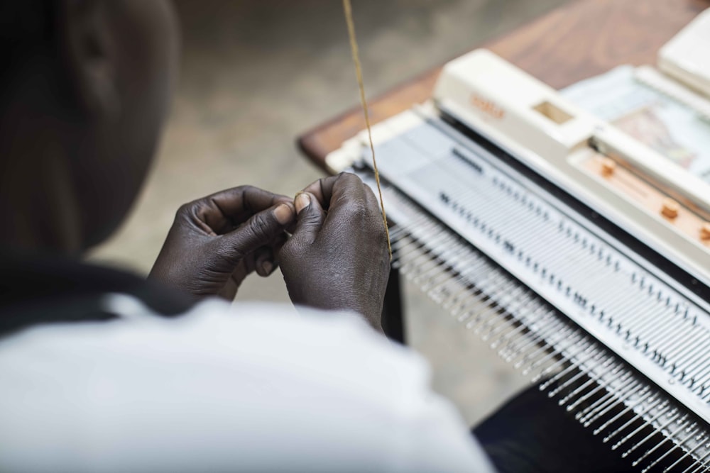 person playing piano with silver ring