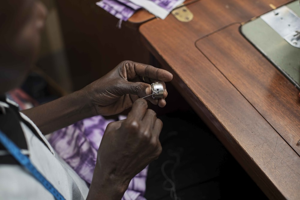 person wearing silver ring and silver ring