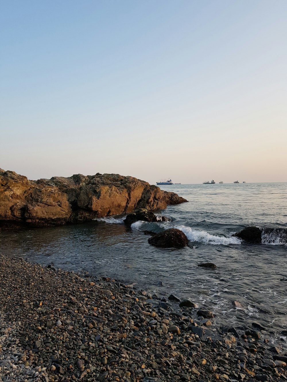 brown rock formation on sea during daytime