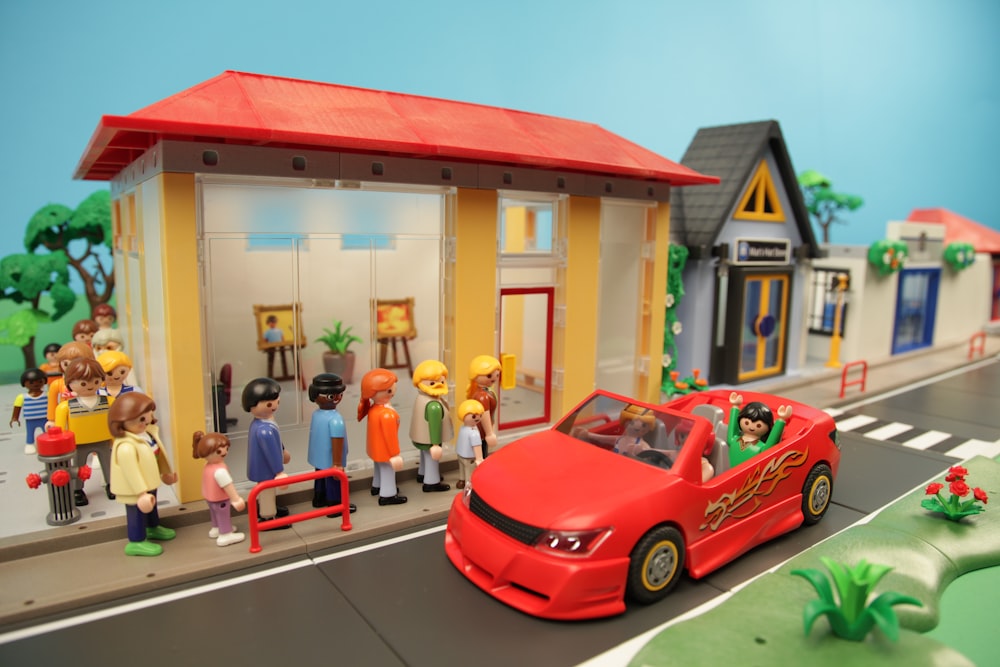 red ferrari coupe parked beside yellow and red building photo – Free  Playmobil Image on Unsplash