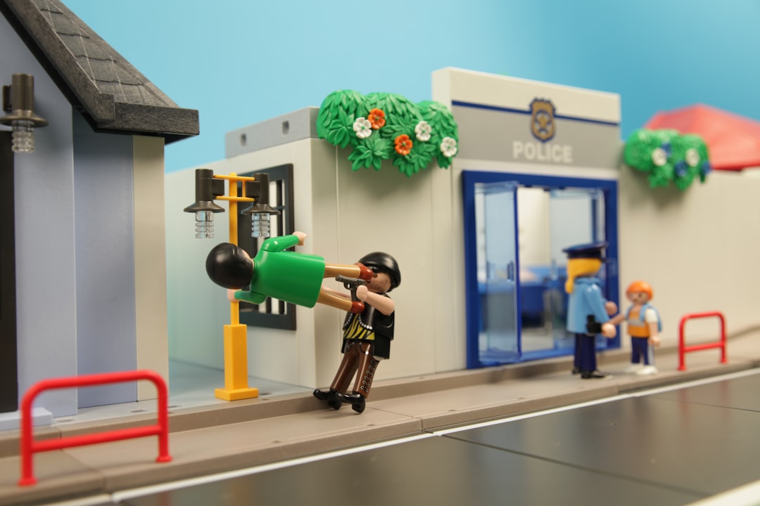black and orange power tool, A playmobil person stopping a bank robber.