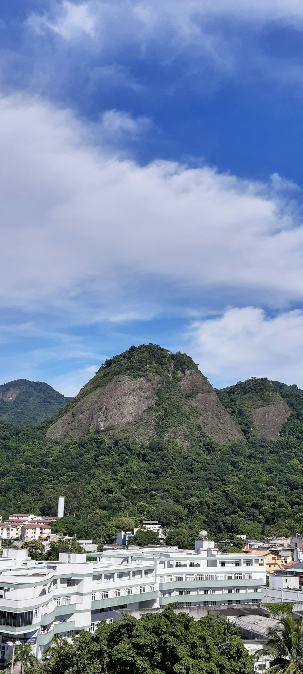 green and brown mountain under white clouds during daytime