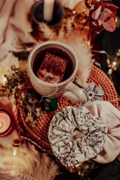 A serene setting with a steaming cup of herbal tea beside a meditation cushion and soft natural light.