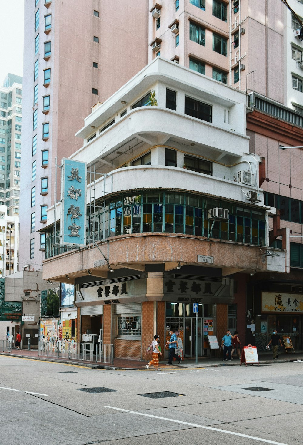 people walking on street near white concrete building during daytime