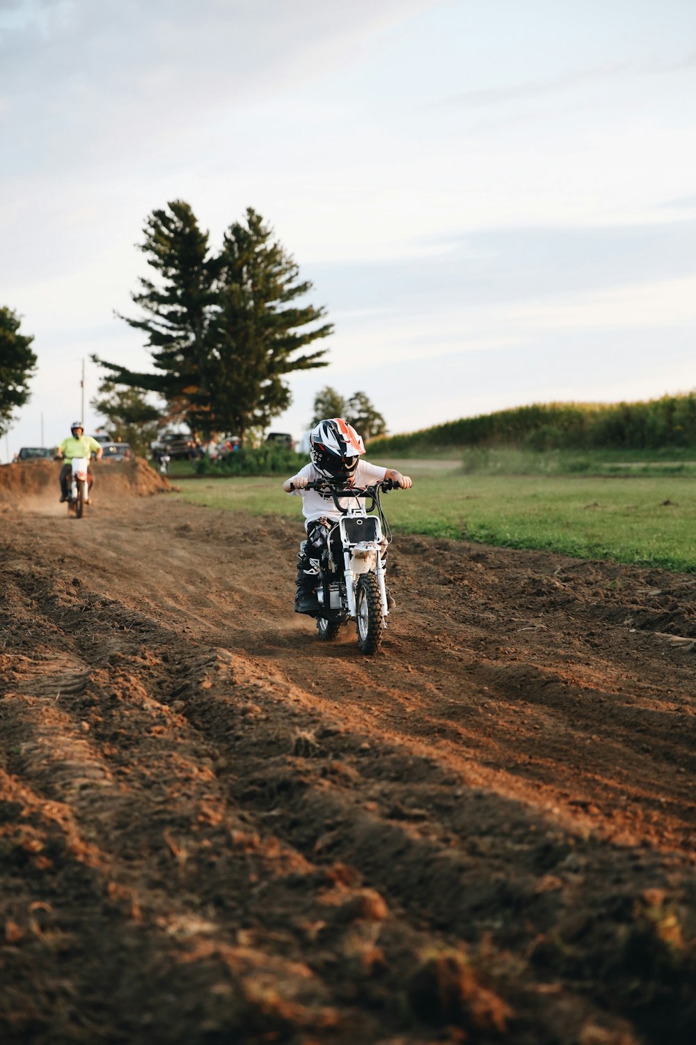 man riding motorcycle on dirt road during daytime