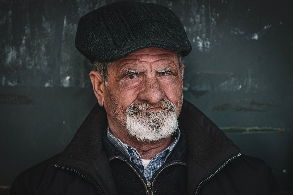 man in black zip up jacket and black cap