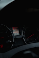 A dimly lit car dashboard displaying various gauges including a speedometer and an odometer. The odometer reads 10747, and there is a digital clock showing the time as 3:17.