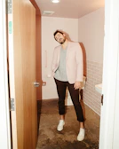 A technician gently adjusting a grab bar in a bright, accessible bathroom for a senior client.