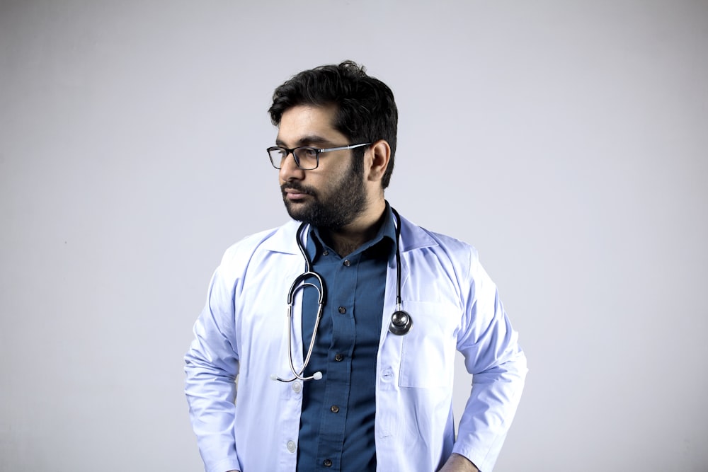 man in white and blue zip up jacket wearing black framed eyeglasses