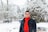 man in black jacket standing on snow covered ground