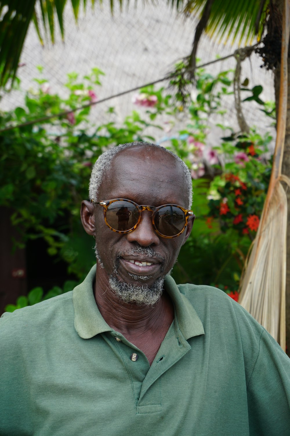 man in green polo shirt wearing sunglasses