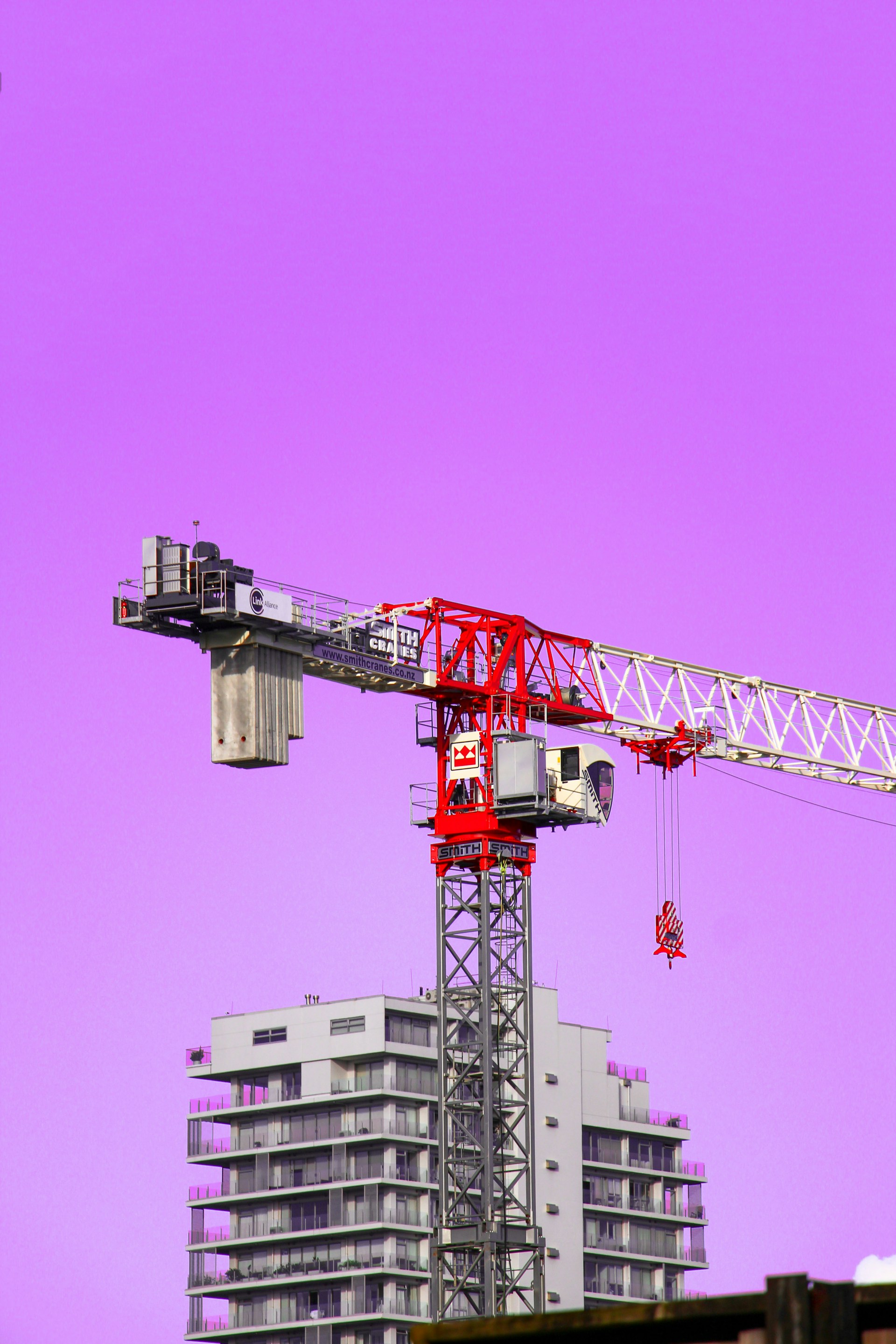 red and gray crane under blue sky during daytime