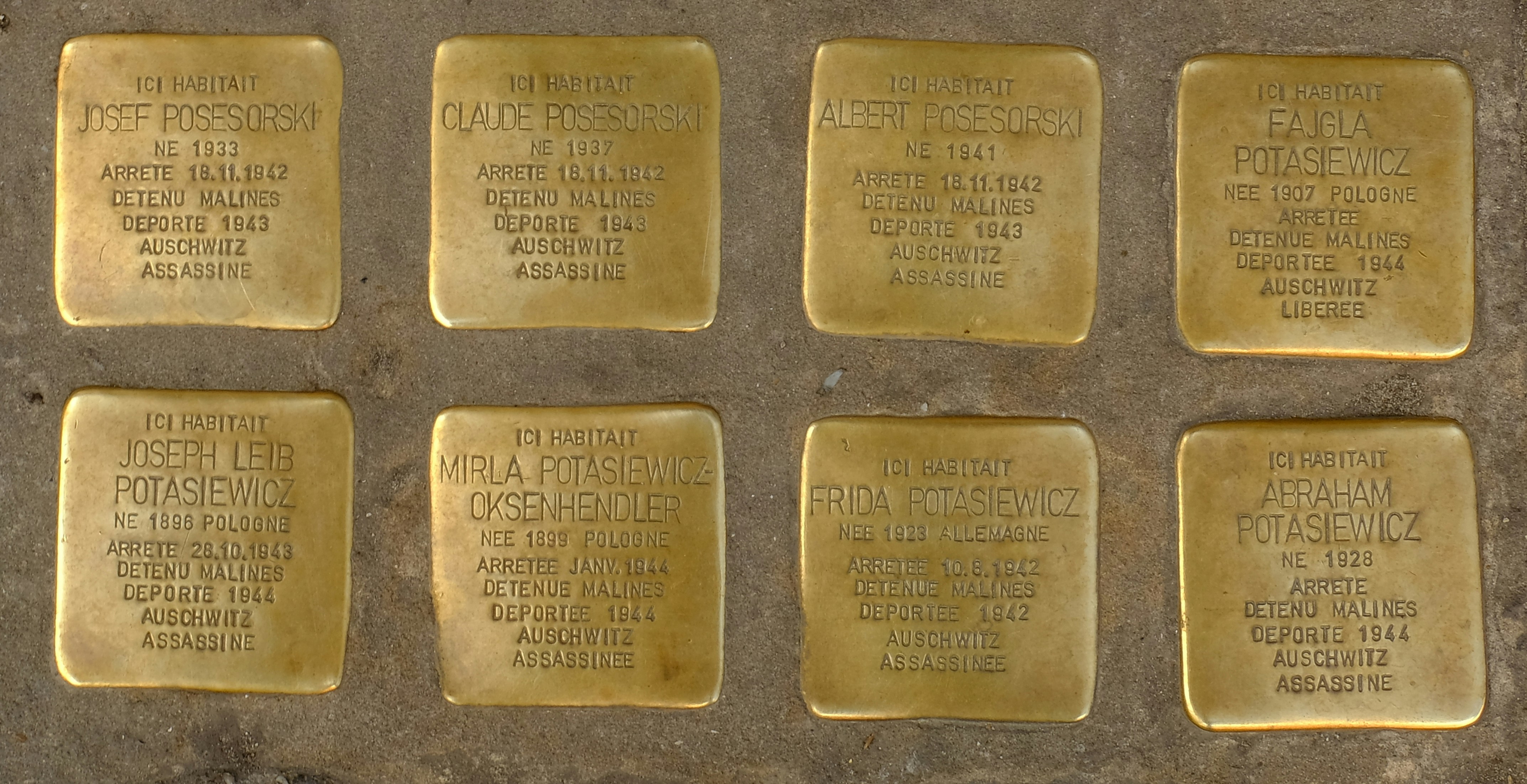 The tiles show the names of people arrested and sent to the Auschwitz extermination camp during WW II. These tiles are cemented into the sidewalk before the house from which they were abducted. Each tile states the name of the person, when arrested and when and whereto deported. Their only crime was having the \
