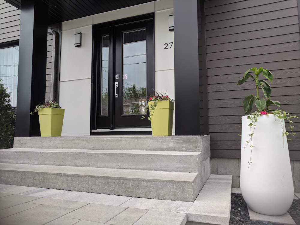 a large white vase sitting on top of a cement step